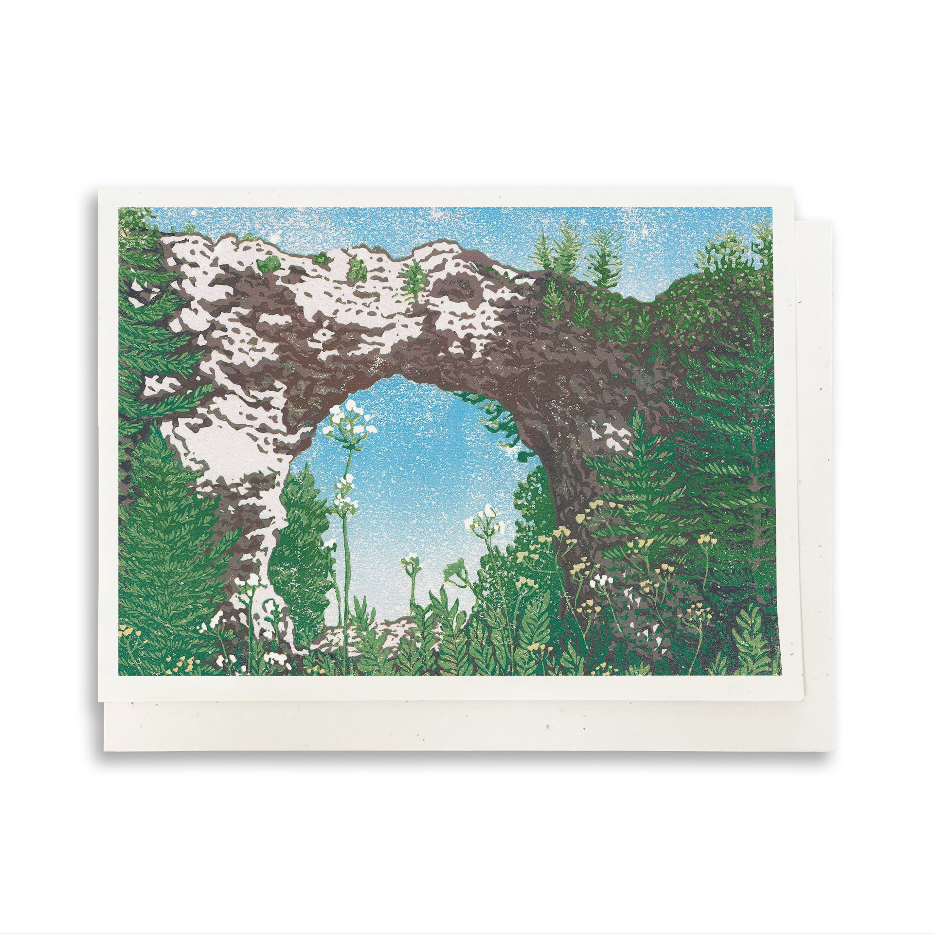 A blank A6 greeting card featuring a block print of Mackinac Island's Arch Rock.