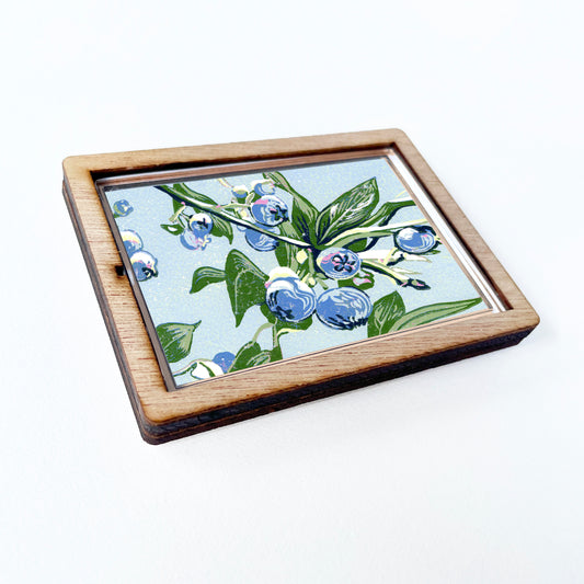 Decorative magnet featuring the block print, "Blueberries," by Peninsula Prints. The magnet has a protective clear coating and wooden frame.