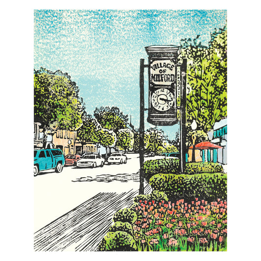 Cars roll down Main Street in Milford, MI, passing colorful shops and restaurants.