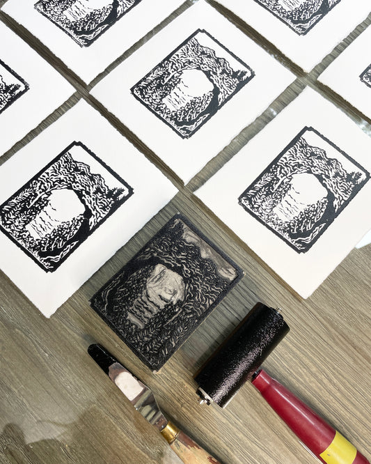 Carving and printing process behind the creation of "Mini Arch Rock", a 3"x4" one-color black and white block print of Arch Rock on Mackinac Island.