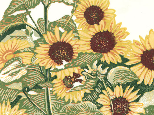 A multicolor block print of seven bright yellow sunflowers stand in a patch.