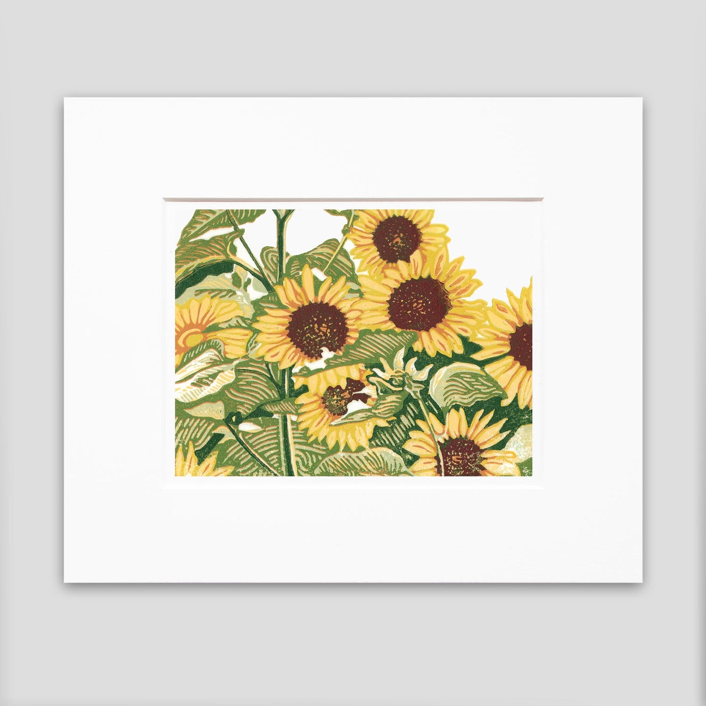 A matted multicolor block print of seven bright yellow sunflowers stand in a patch.