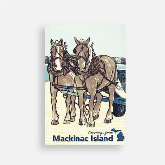 Post card with block print design of two horses and the text 'Greetings from Mackinac Island' on a light blue background.