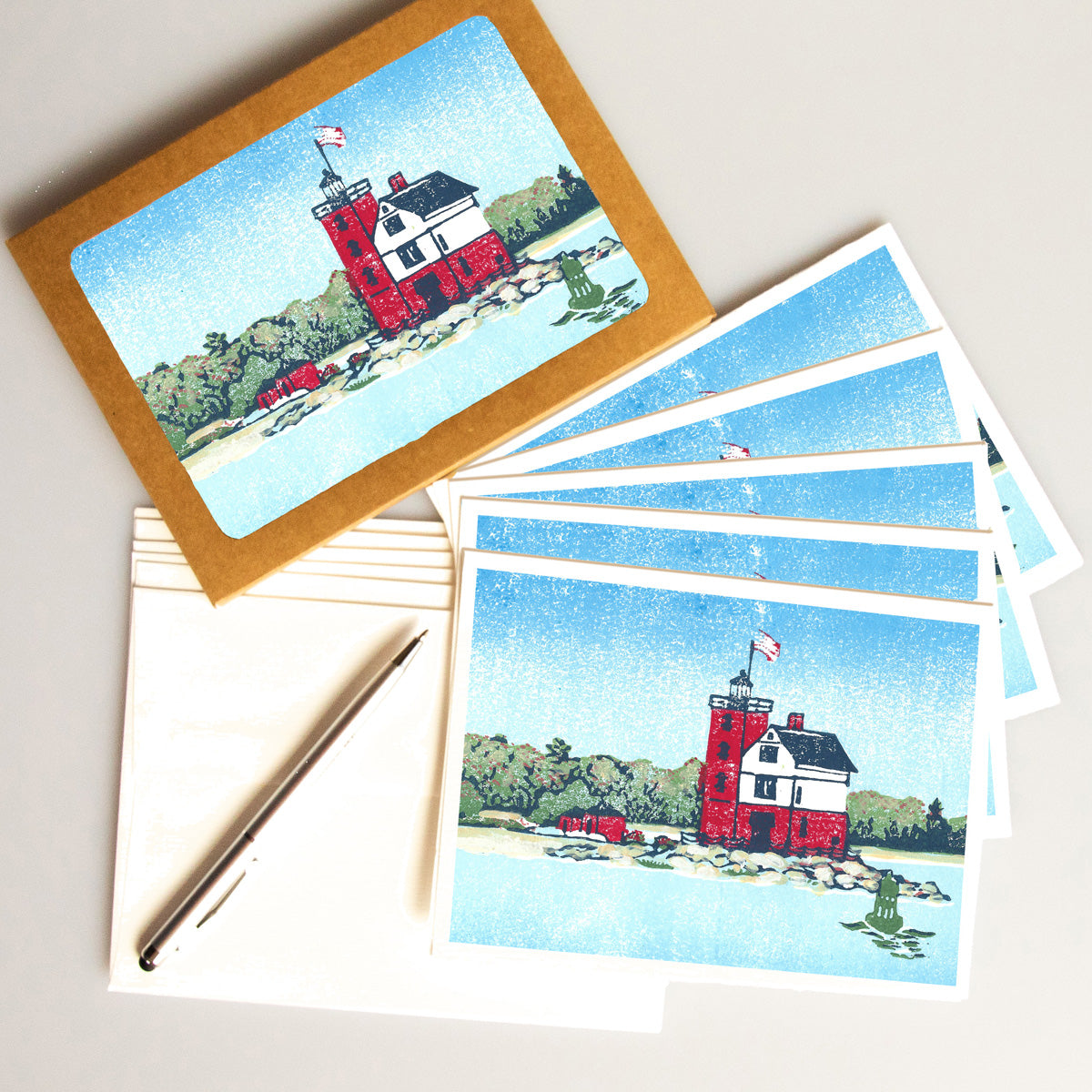 A casually elegant card set featuring lighthouse art by Natalia Wohletz of Peninsula Prints titled Round Island Light.