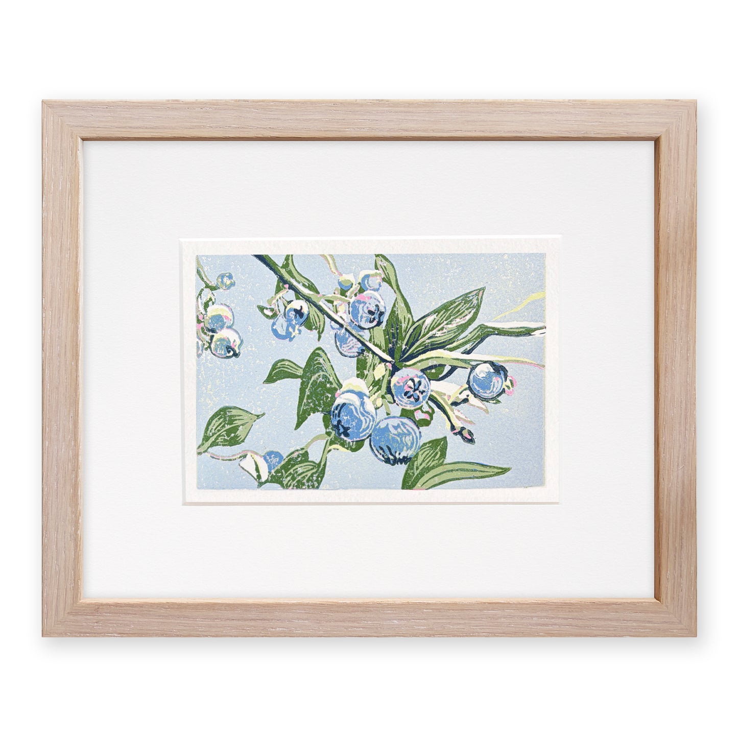 Framed artwork of blueberries and green leaves on a light blue background, with a light, cerused oak frame.
