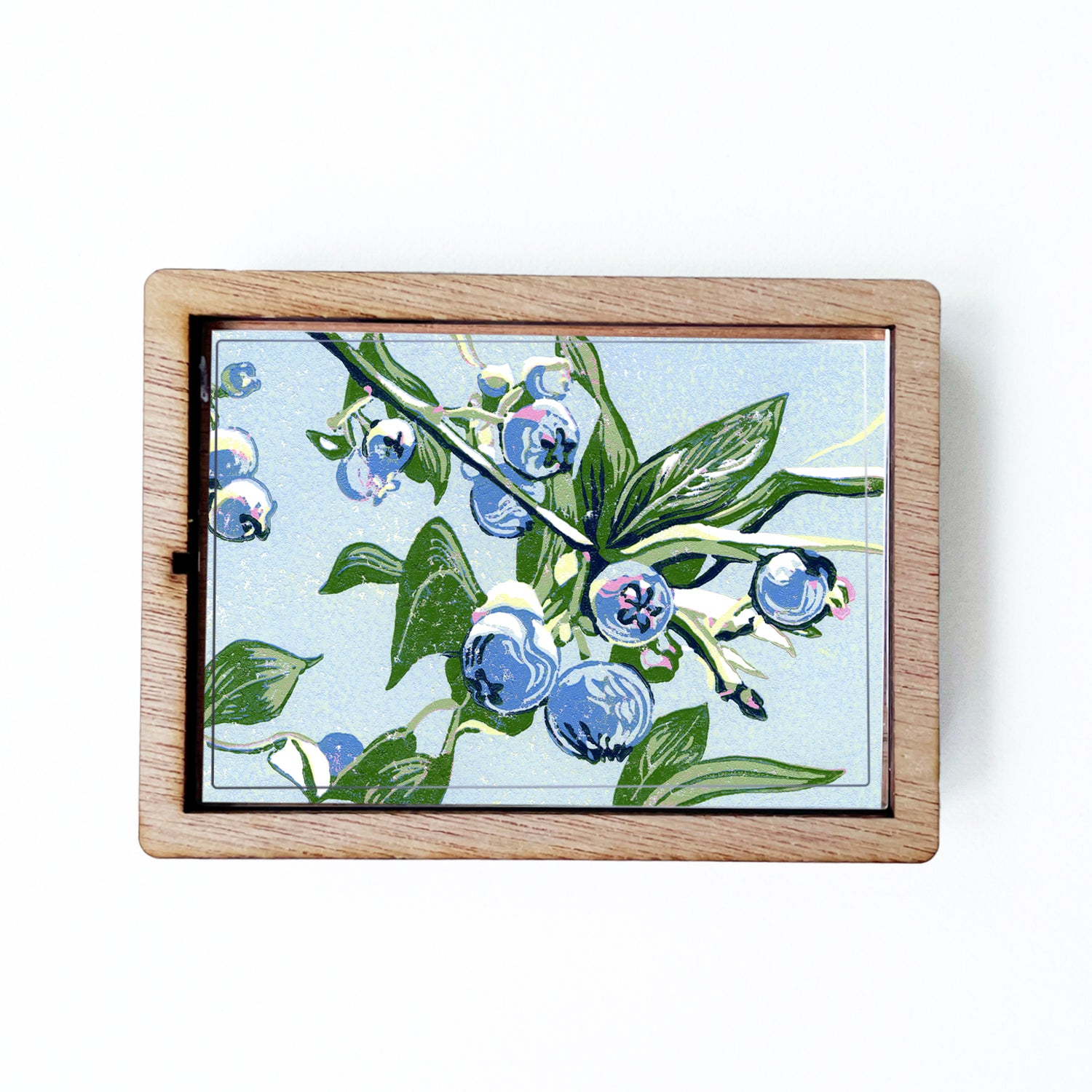 Decorative magnet featuring the block print, "Blueberries," by Peninsula Prints. The magnet has a protective clear coating and wooden frame.