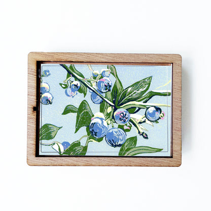 Decorative magnet featuring the block print, "Blueberries," by Peninsula Prints. The magnet has a protective clear coating and wooden frame.