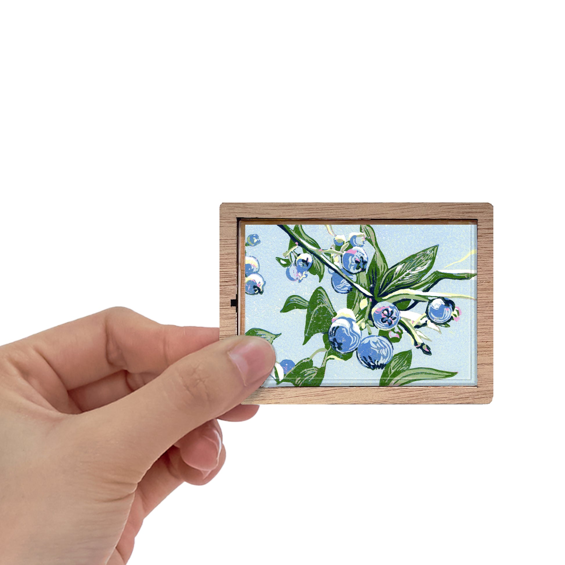 Decorative magnet featuring the block print, "Blueberries," by Peninsula Prints. The magnet has a protective clear coating and wooden frame.