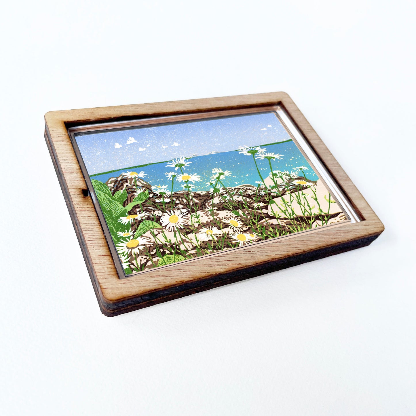 Decorative magnet featuring the block print, "Daisy Shore," by Peninsula Prints. The magnet has a protective clear coating and wooden frame.