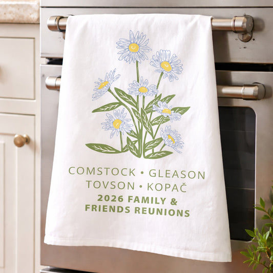 White towel with floral design and text hanging on a kitchen rack. Custom Flour Sack Towel