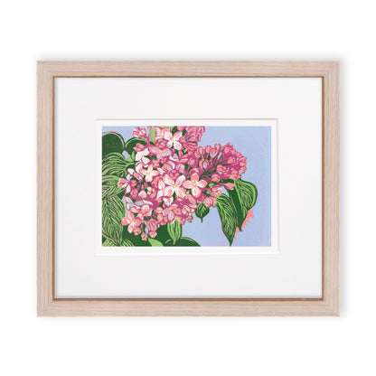 Reduction block print of blooming pink lilacs with olive green leaves against a periwinkle background. Matted in white and framed in a narrow cerused oak frame.