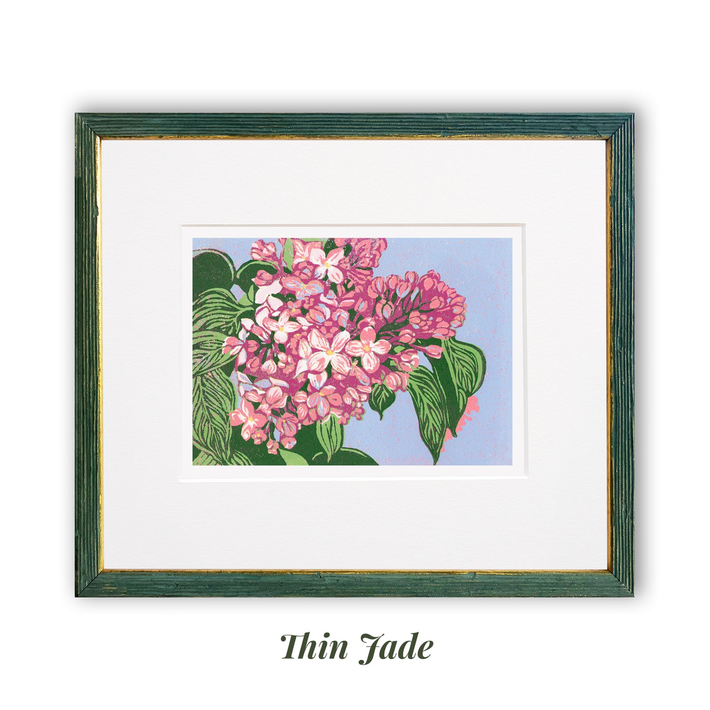 Reduction block print of blooming pink lilacs with olive green leaves against a periwinkle background. Matted in white and framed in a narrow jade and gold frame.