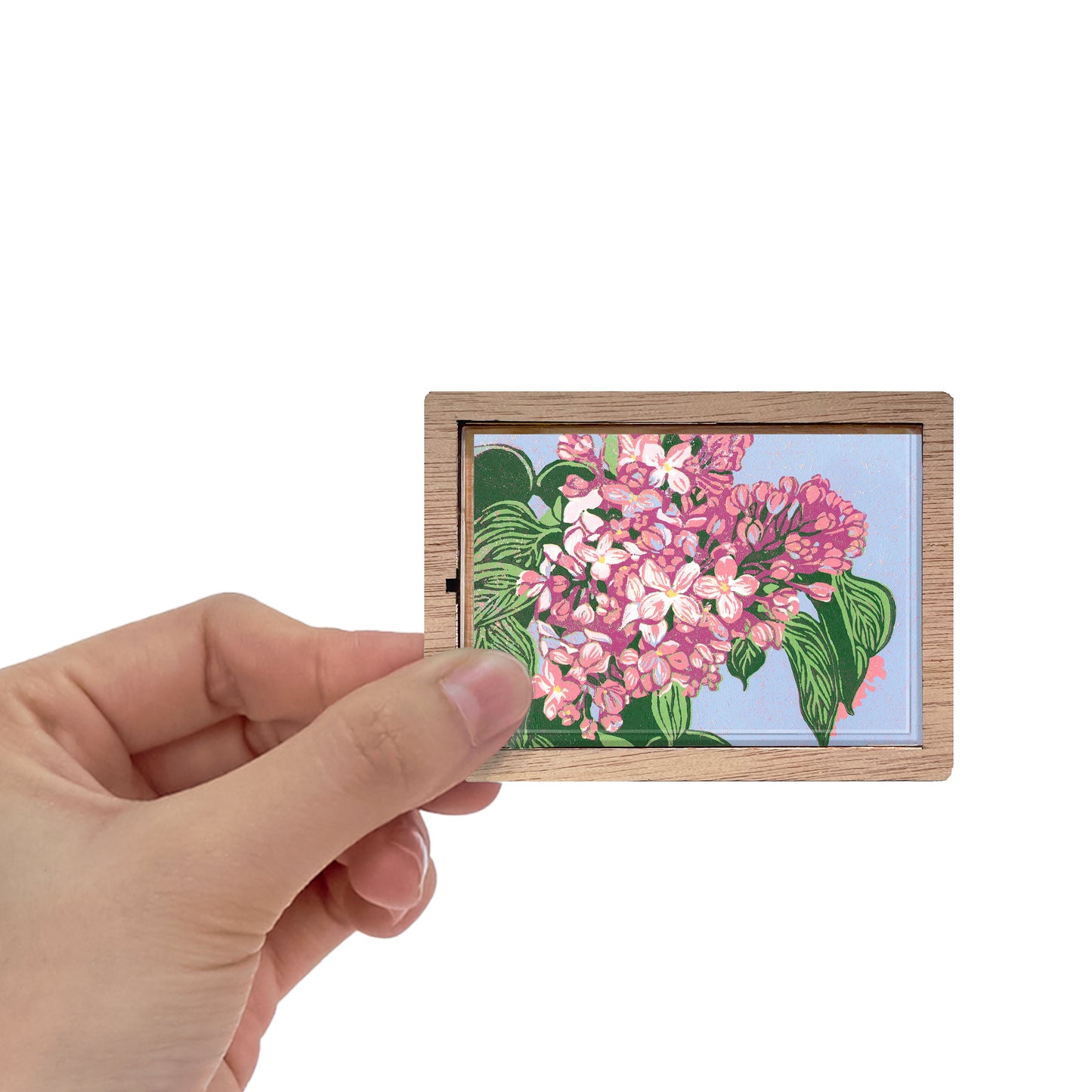 Decorative magnet featuring the block print, "Lilacs," by Peninsula Prints. The magnet has a protective clear coating and wooden frame.