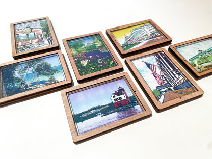 Set of wooden picture frames magnets with scenic artwork on a white background