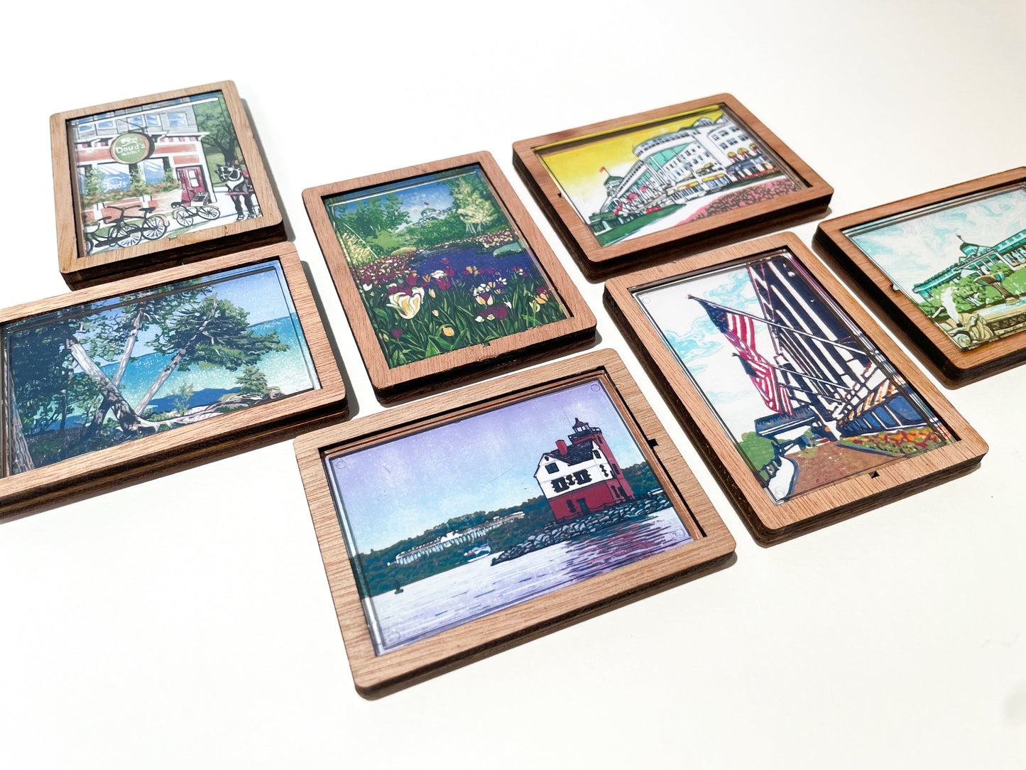 Set of wooden picture frames magnets with scenic artwork on a white background