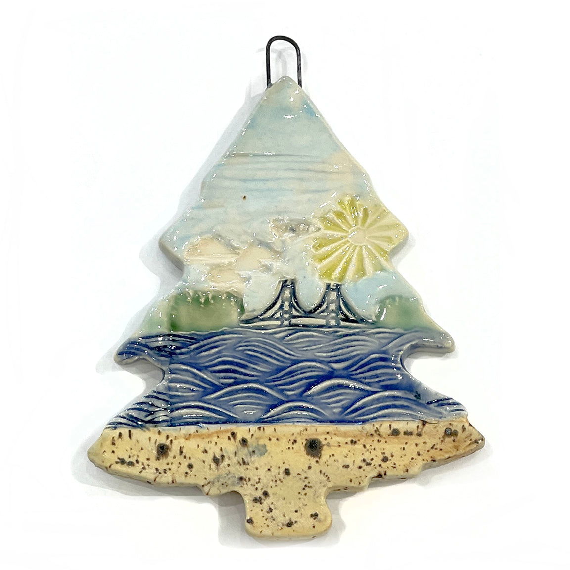 3" ceramic tree ornament featuring the Mackinac Bridge spanning the Great Lakes on a sunny day. Collaboration between Michigan artists Jeanne DeHaan and Natalia Wohletz.
