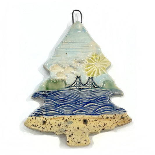 3" ceramic tree ornament featuring the Mackinac Bridge spanning the Great Lakes on a sunny day. Collaboration between Michigan artists Jeanne DeHaan and Natalia Wohletz.