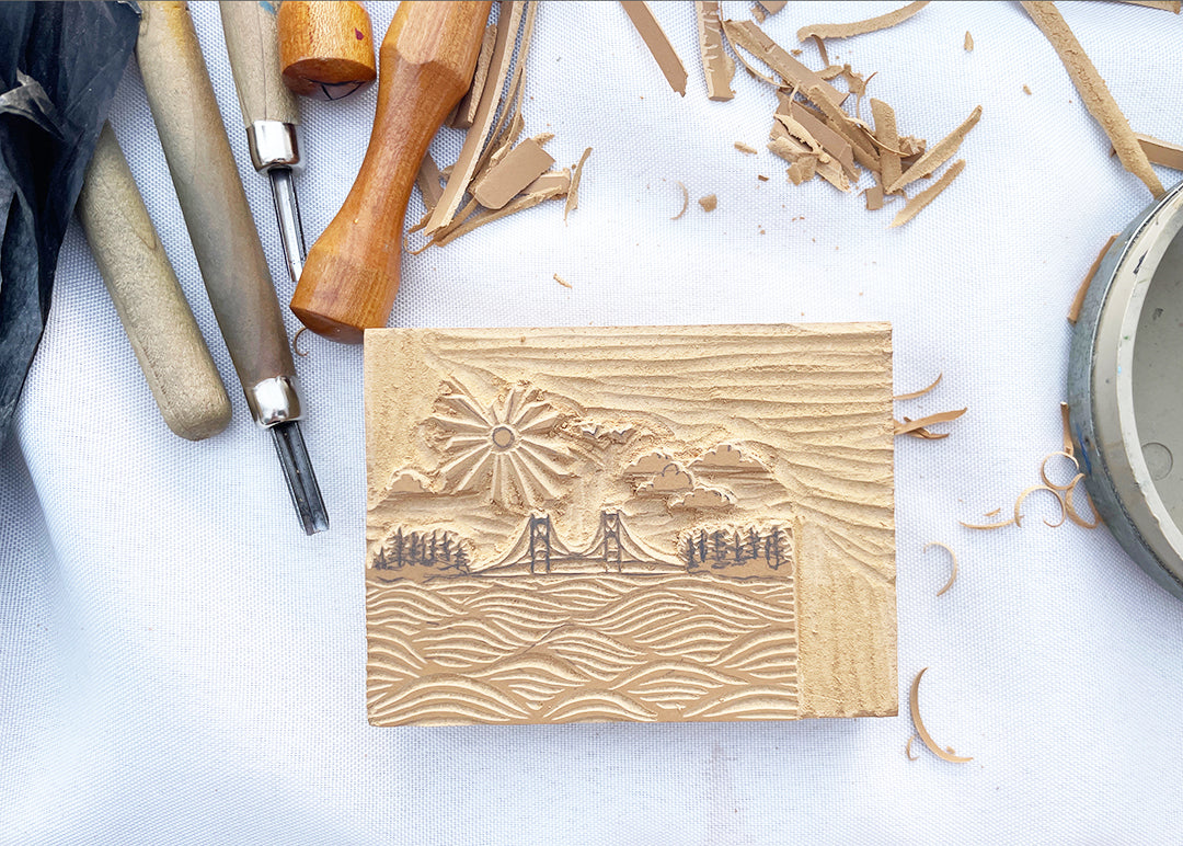 Original Mackinac Waves block used to create a 3" ceramic tree ornament featuring the Mackinac Bridge spanning the Great Lakes on a sunny day. Collaboration between Michigan artists Jeanne DeHaan and Natalia Wohletz.