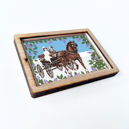 Decorative magnet featuring the block print, "Somewhere in Time Carriage Ride," by Peninsula Prints. The magnet has a protective clear coating and wooden frame.