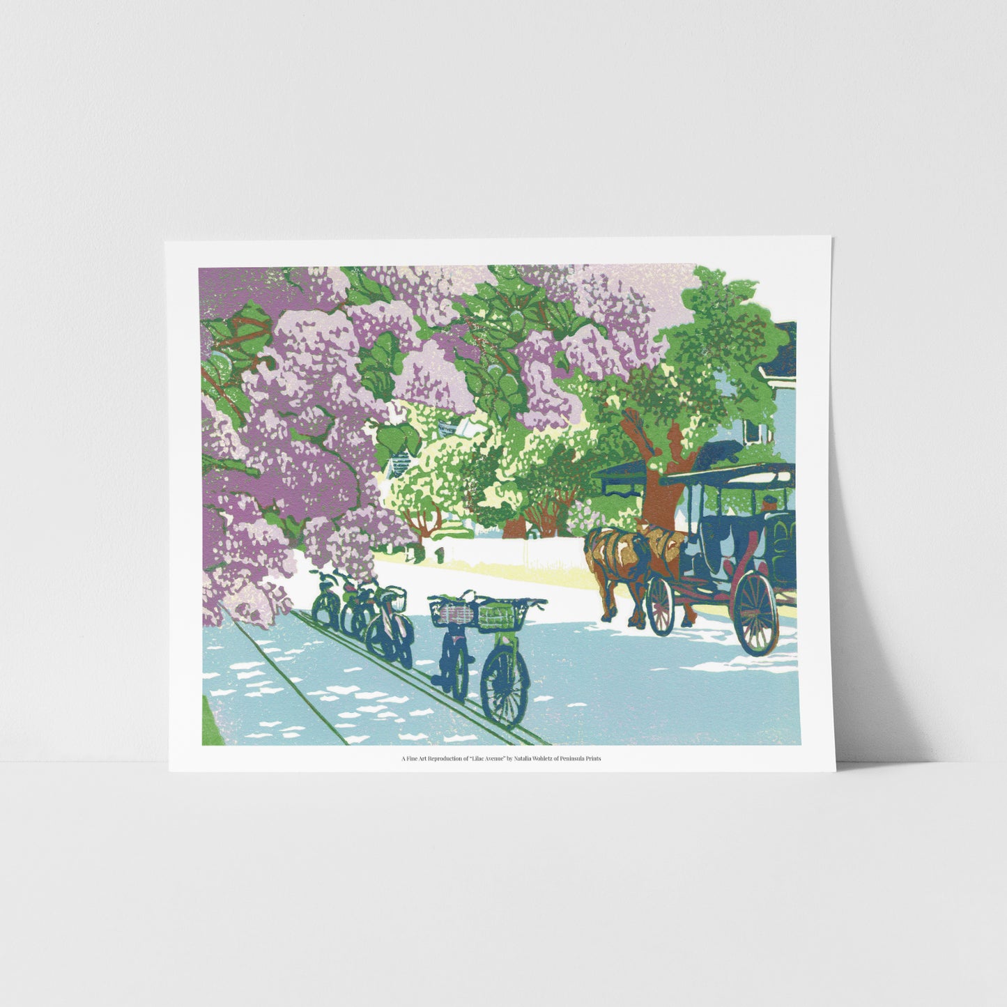 A fine art reproduction of "Lilac Avenue," a nine-color 10" x 8" block print with gold embellishments showcasing a dreamy street on Mackinac Island during the Lilac Festival with the wonderfully-smelling lilac bushes are in full bloom.  
