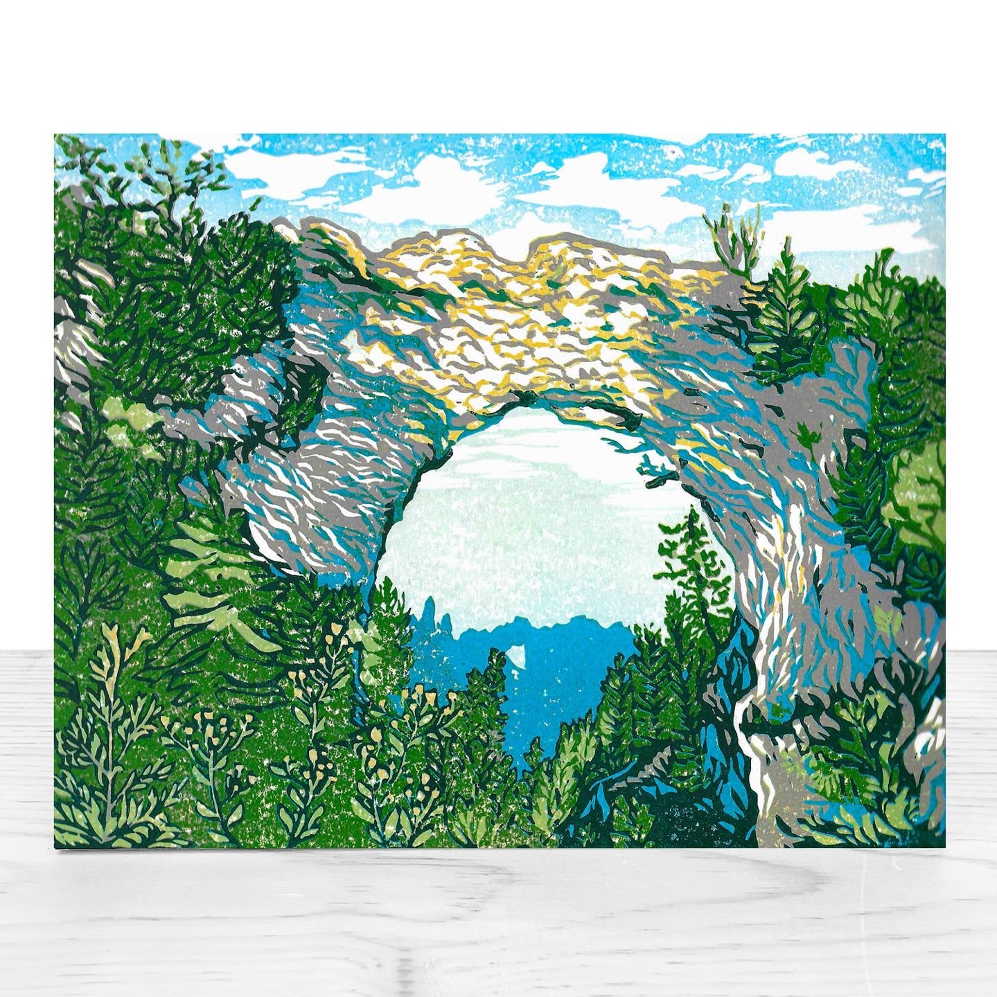 A high-quality, mounted giclée fine art print of a lino cut block print design by award-winning artist Natalia Wohletz, Peninsula Print, titled Arch Rock's Shadow.