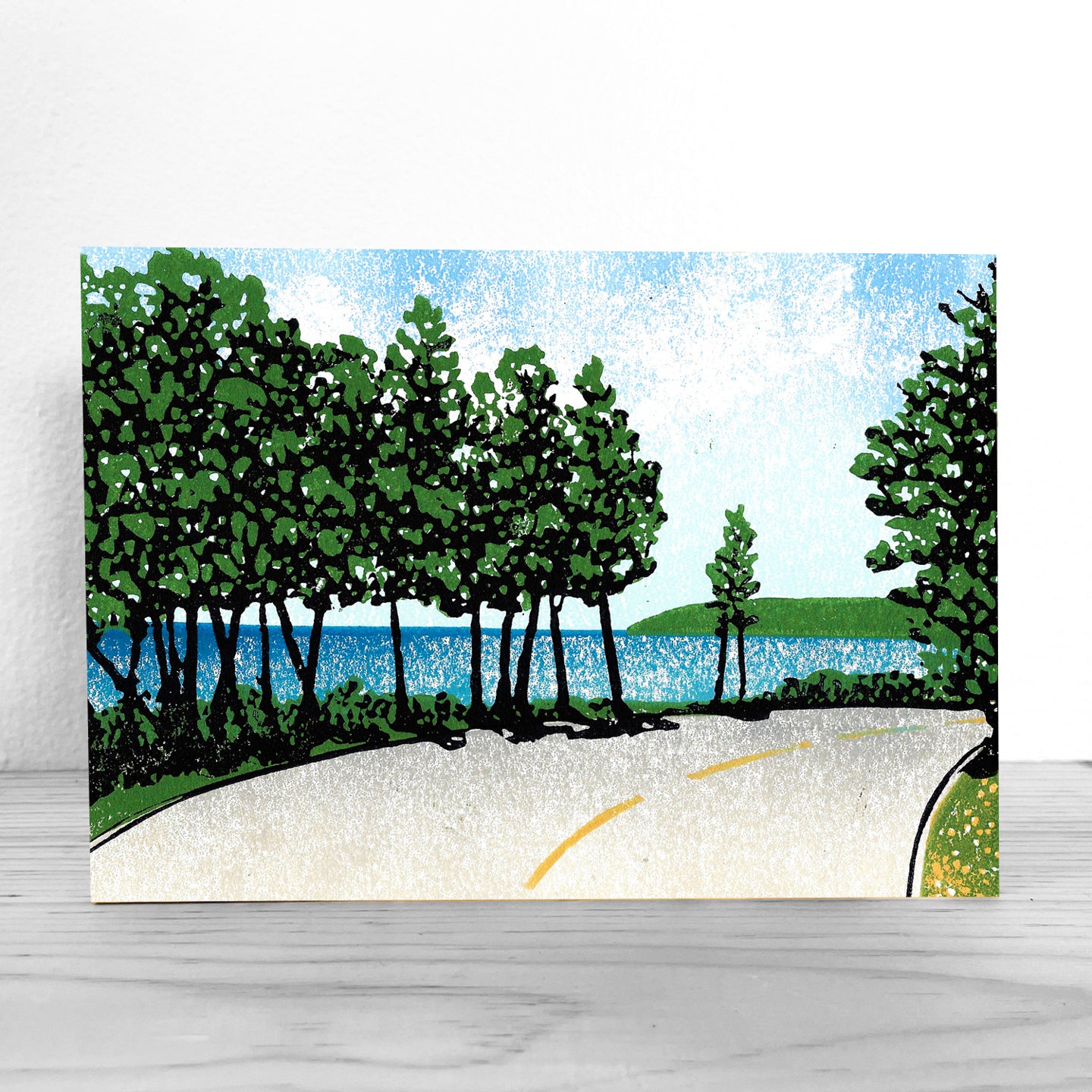 A high-quality, mounted giclée fine art print of a lino cut block print design by award-winning artist Natalia Wohletz, Peninsula Print, titled Bend by the Bay.