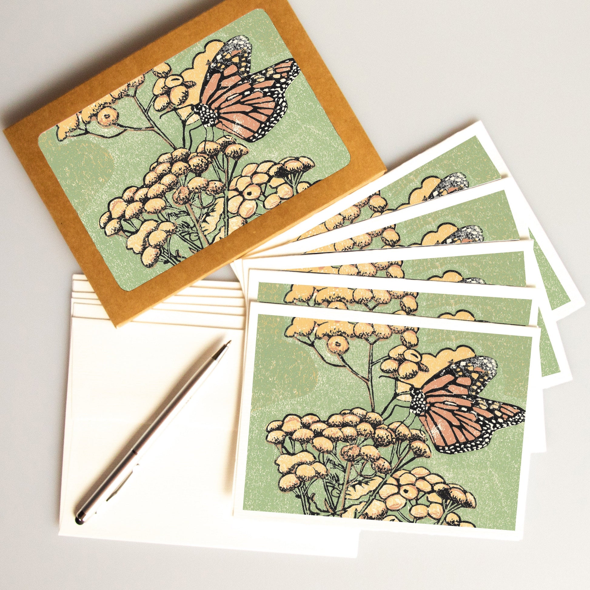 A casually elegant card set featuring monarch butterfly art by Natalia Wohletz titled Monarch on Tansy.